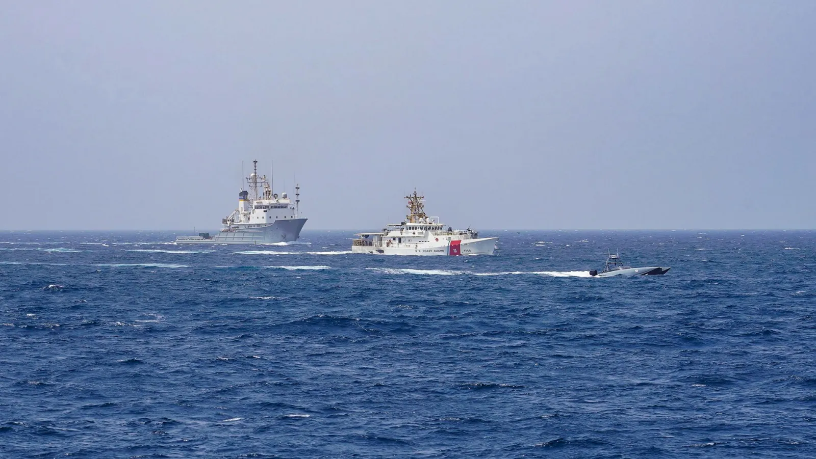 U.S. Navy and Coast Guard vessels crossing the Strait of Hormuz in June 2023; archival image, not the 2026 talks.